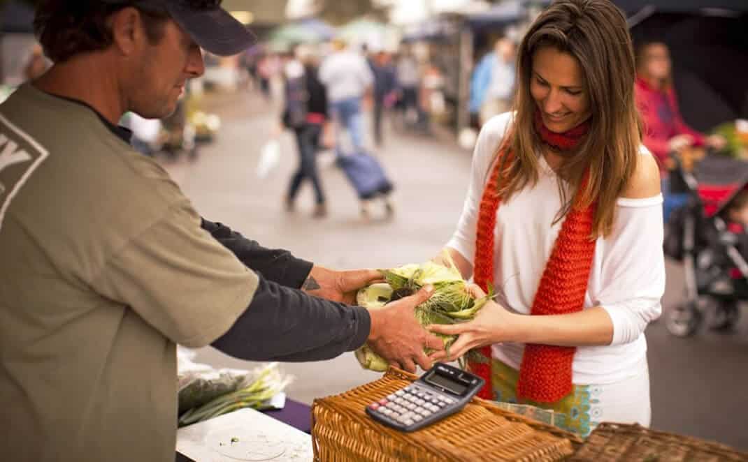 Lady buying cabbage in market