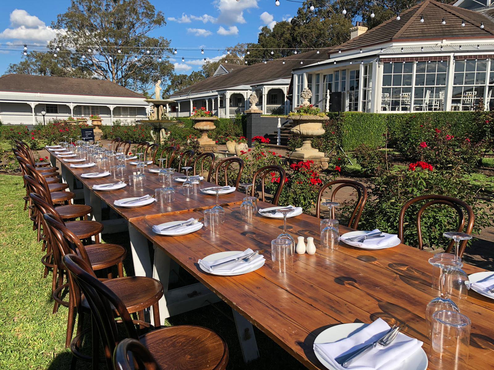 A long table set for a celebration in the rose garden at voco Kirkton Park