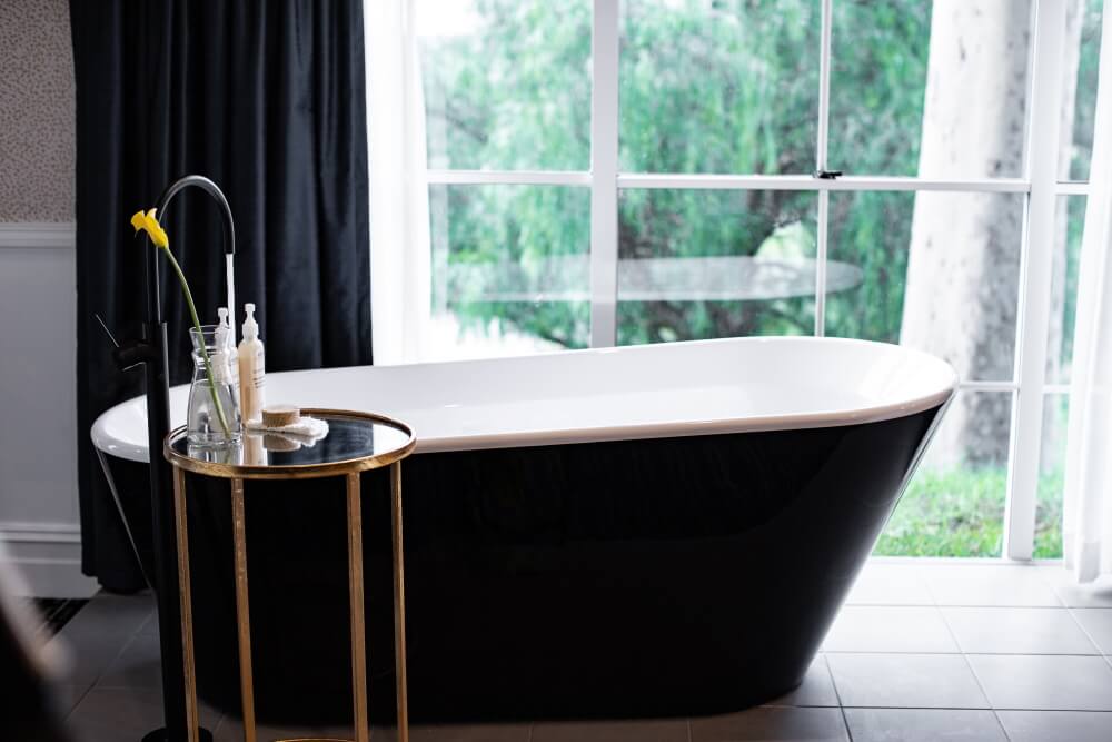 Claw foot bath in front of the window in the Signature Suite at voco Kirkton Park