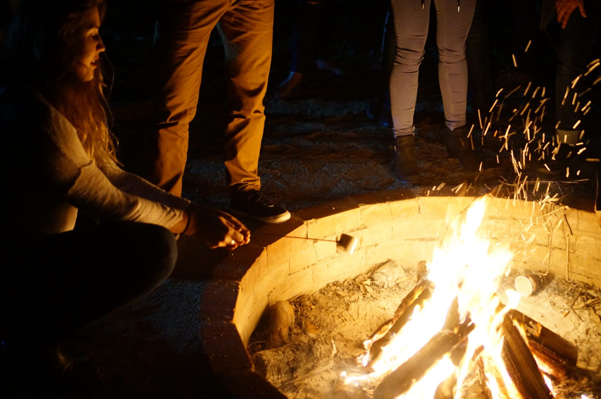 The outdoor fire pit at voco Kirkton Park at night