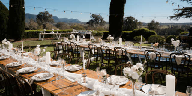 A beautifully arranged table setting at voco™ Kirkton Park Hunter Valley, featuring elegant decor and a picturesque backdrop, perfect for an intimate gathering or special event.