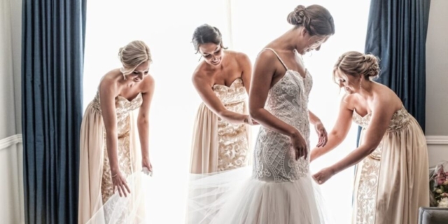 Bride getting ready with her bridesmaids in an elegantly decorated room.